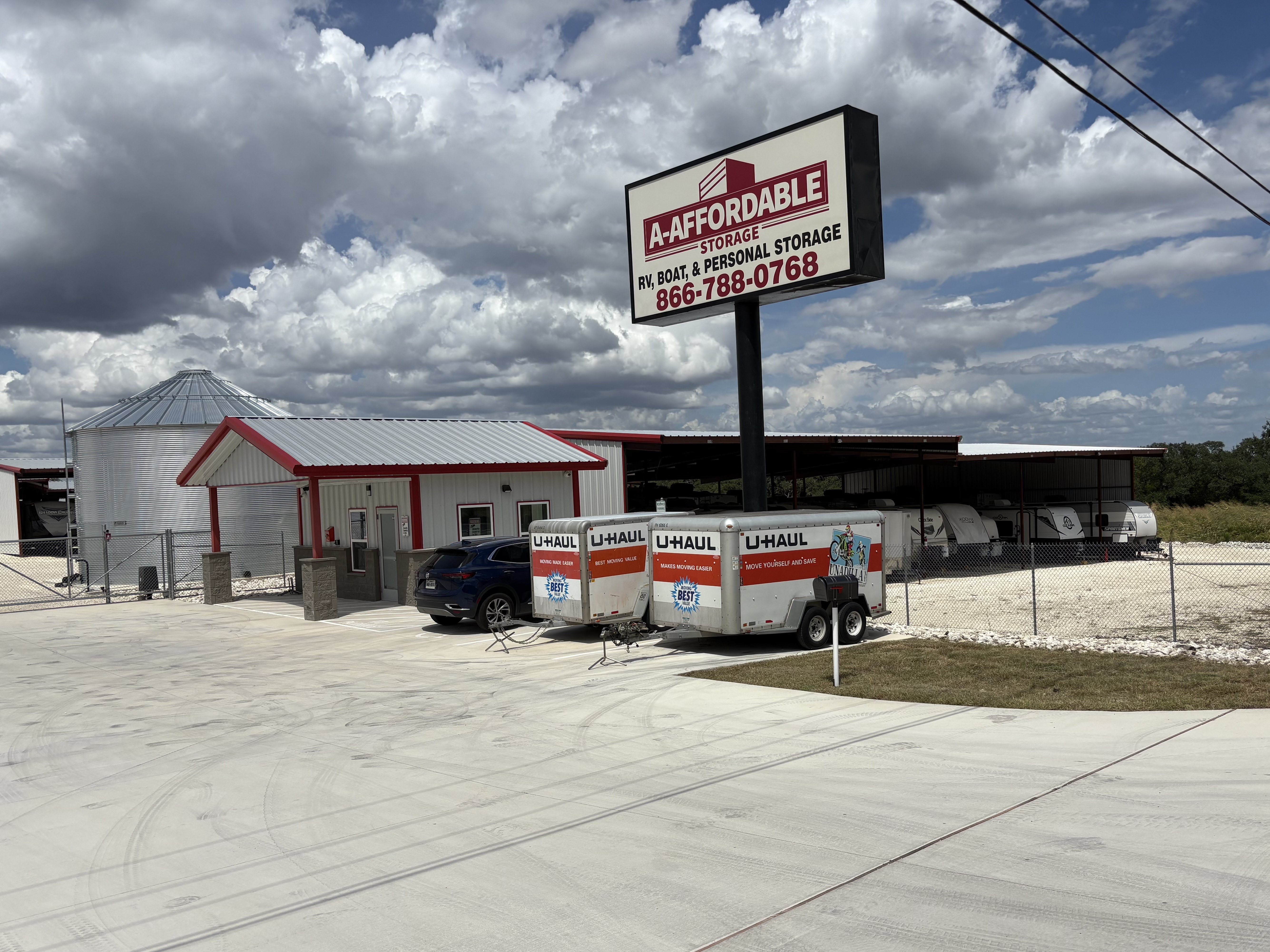 Covered RV and boat storage facility in Boerne, Texas with secure gated access, U-Haul rentals, and spacious parking options